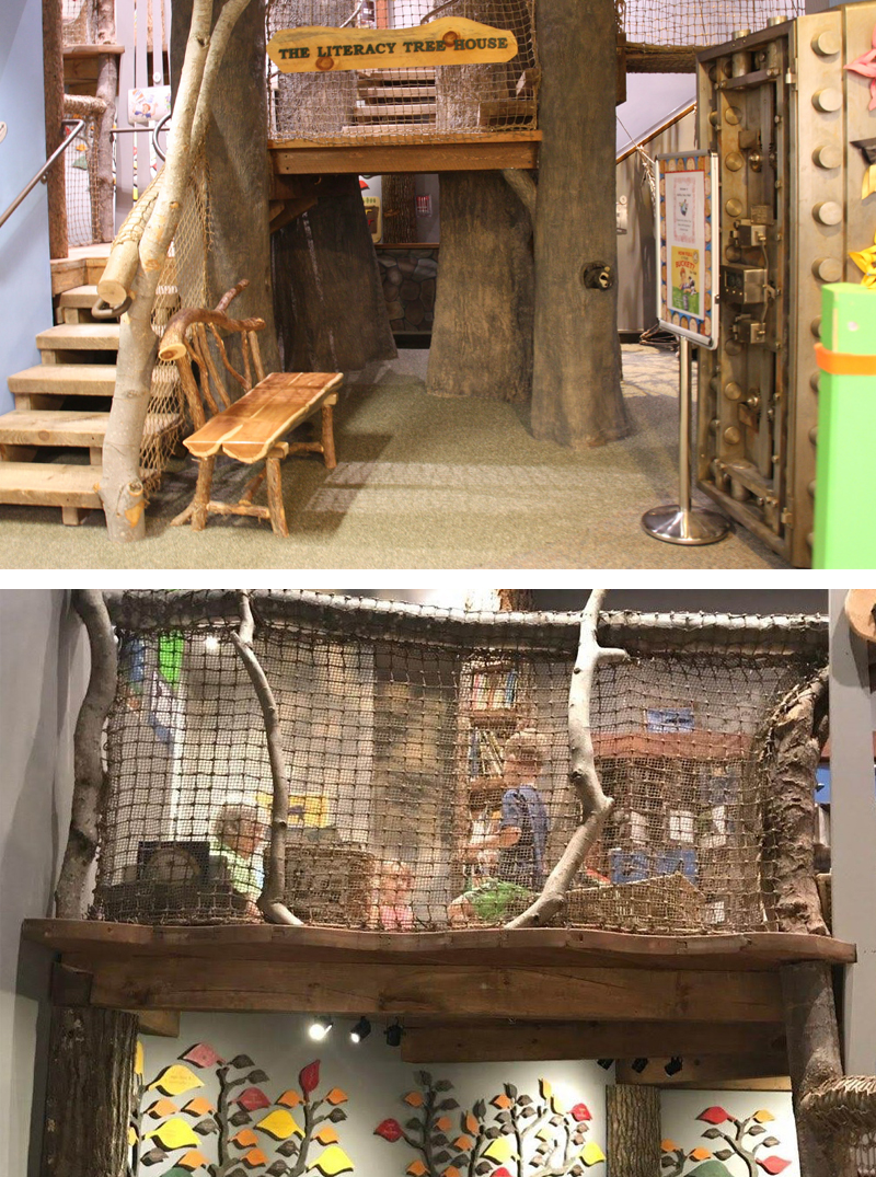 Exhibit of Literacy Tree House with stairs leading to rope netted platform.