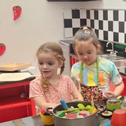 A photo of two girls playing together in the KidsPlay Diner.