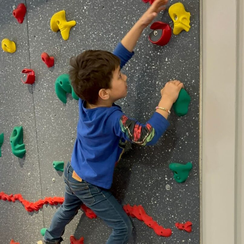 A photo of a boy playing on the Traverse Climbing Wall at KidsPlay Children's Museum in Torrington, CT.