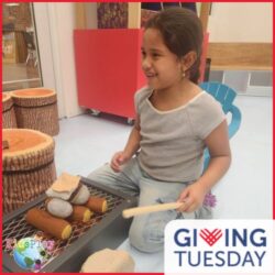 A photo of a girl playing at KidsPlay. The photo has a red border. The GivingTuesday logo is in the lower right hand corner and the KidsPlay logo is in the lower left hand corner.